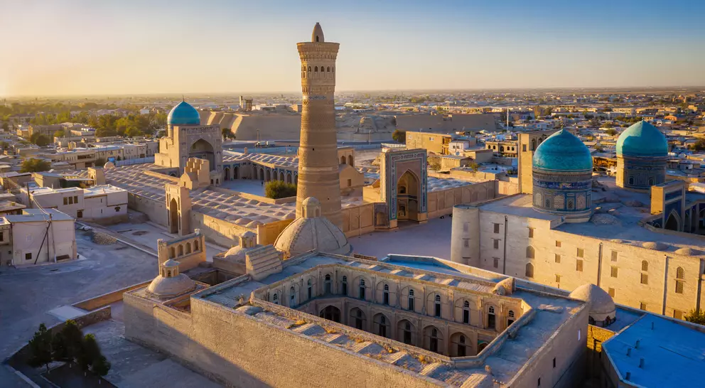 Sunset over the famous Kalyan Poi Kalon Minaret, Poi Kalan or Po-i-Kalyan and Mir Arab Madrasah in the center of the old town of Bukhara