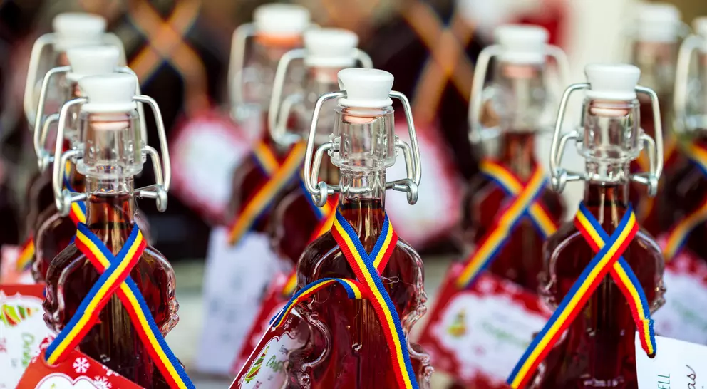 Bottles of Romanian visinata - a liqueur made from sour cherries - in a row and for sale at a food and drink market in Transylvania