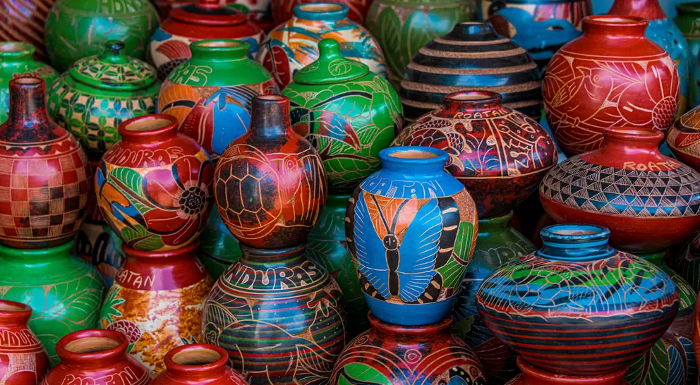 A colorful display of intricately painted ceramic pots in various patterns and designs.