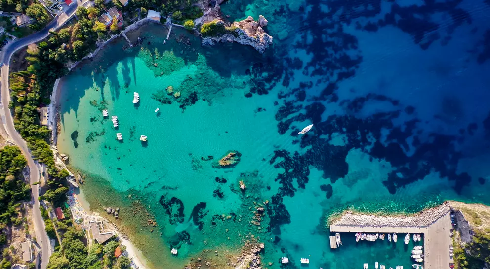 Aerial view of the coastline shot from the air, showing deep blue colours of the Mediterranean Sea.