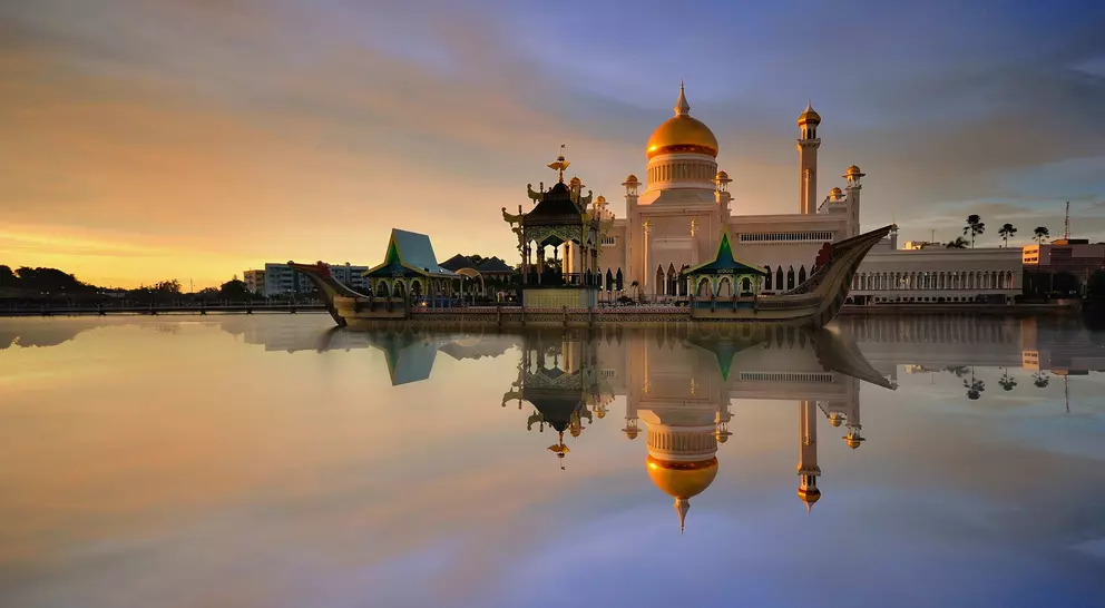 Sunset view of Sultan Omar Ali Saifudding Mosque, Bandar Seri Begawan, Brunei, Southeast Asia with reflection in water