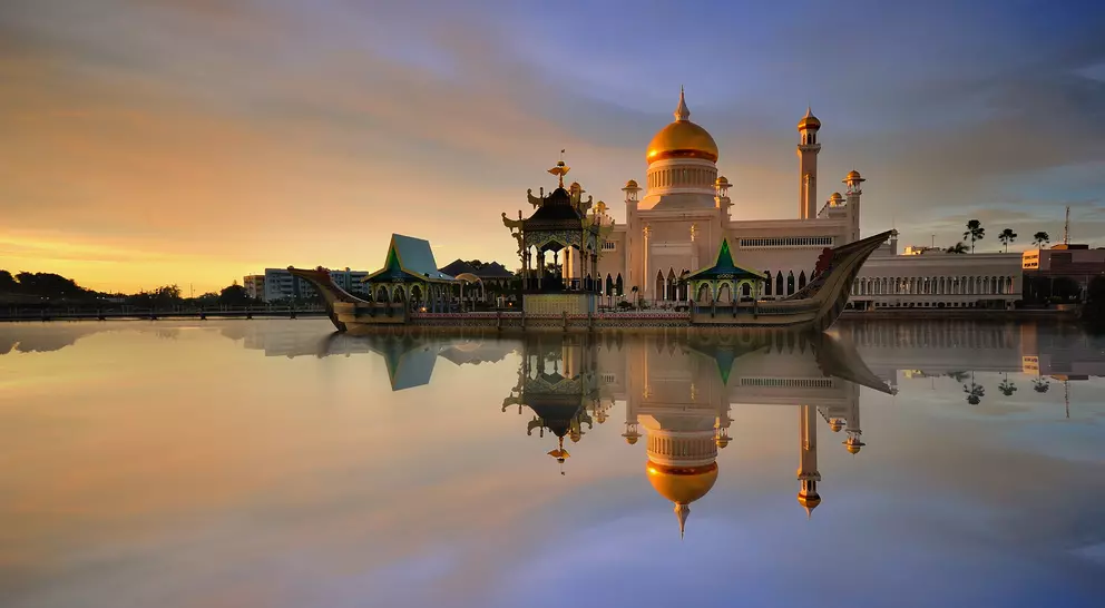 Sunset view of Sultan Omar Ali Saifudding Mosque, Bandar Seri Begawan, Brunei, Southeast Asia with reflection in water