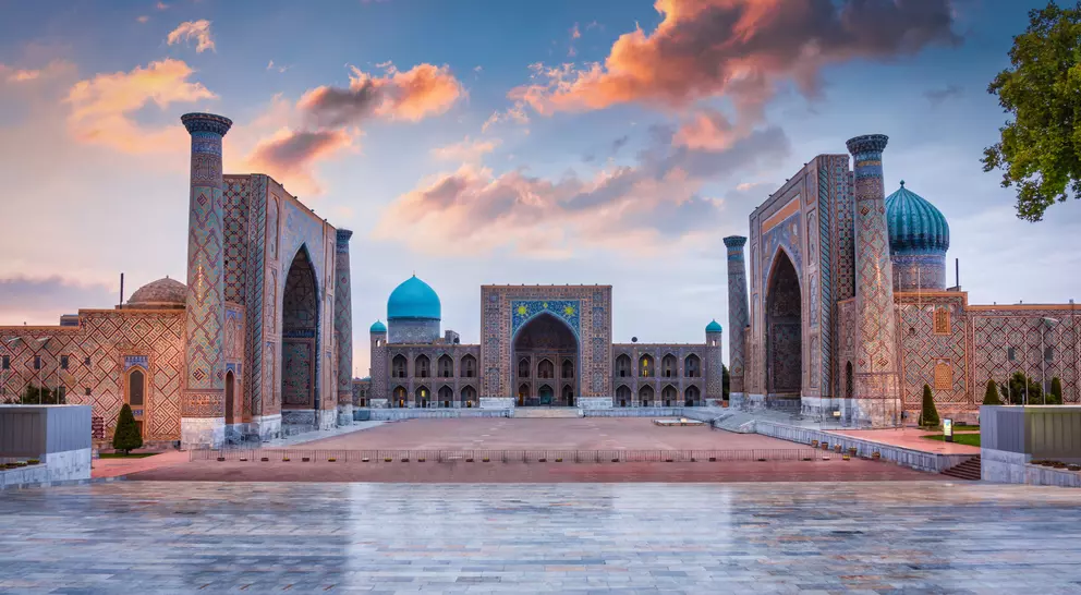 Samarkand Registan Square with Sher-Dor, Ulugh Beg and Tilya-Kori Madrasahs under colorful moody sunset twilight cloudscape