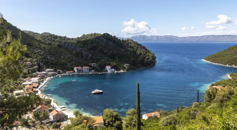 Rural village nestled on bay surrounded by blue waters
