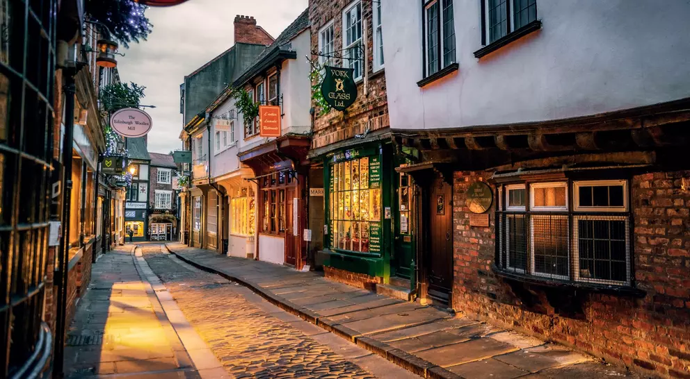 The Shambles, a medieval street preserved in the heart of the English city of York, still busy with boutique shops and cafes