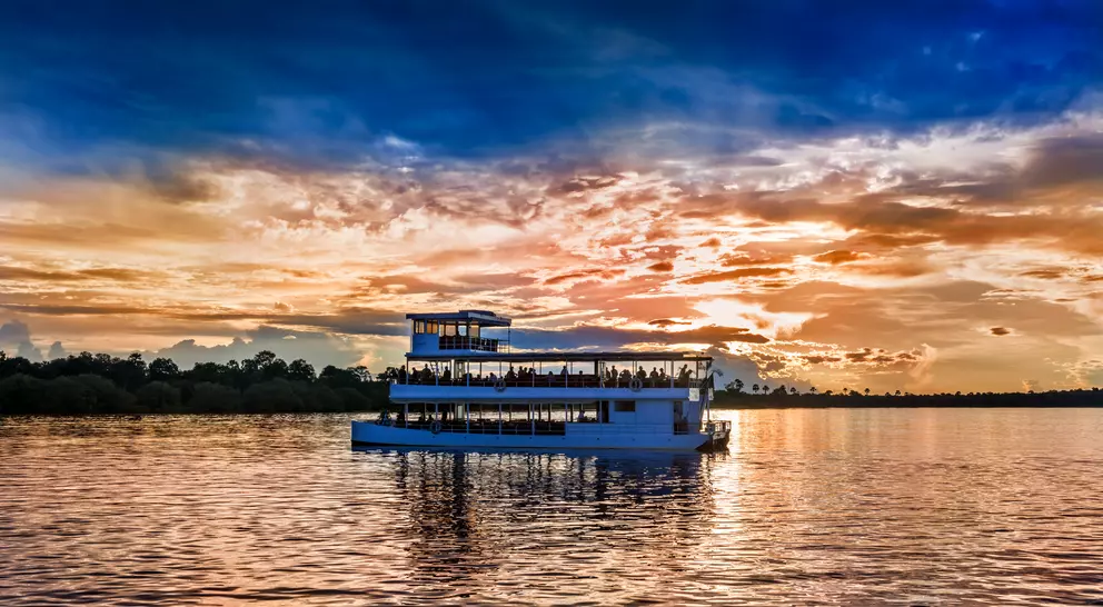 Picturesque sunset landscape with the riverboat at Zambezi river