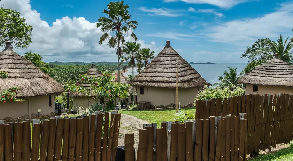 African bungalow with thatched roof and built in old tradition on a hill in Axim overlooking the sea located in Ghana West Africa