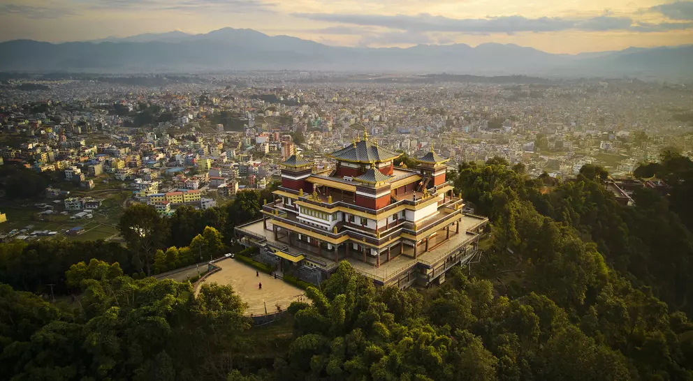 "Pullahari Monastery, Buddhist pilgrimage site on northern hill in Kathmandu Valley with city and mountains in background. "