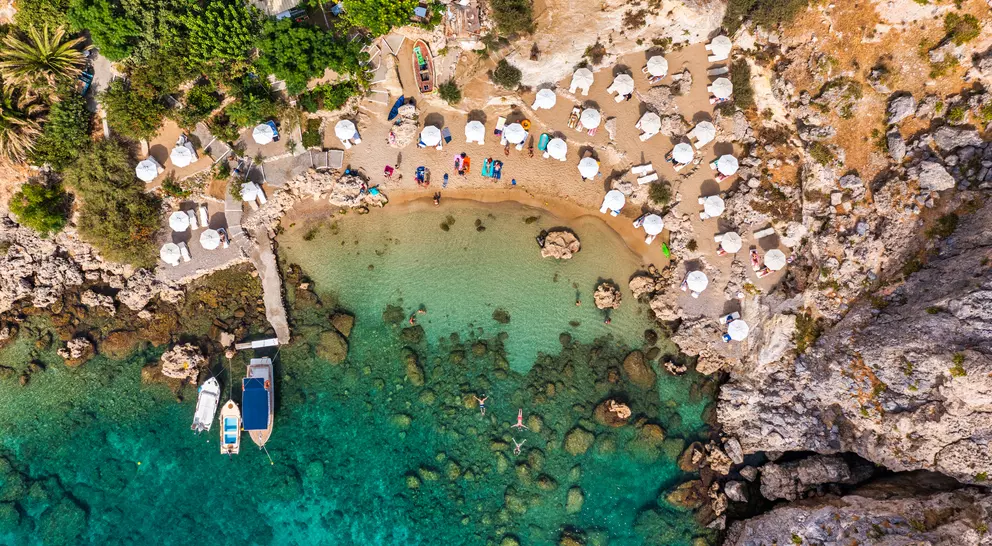 Aerial photo of beach goes and boats in the bay