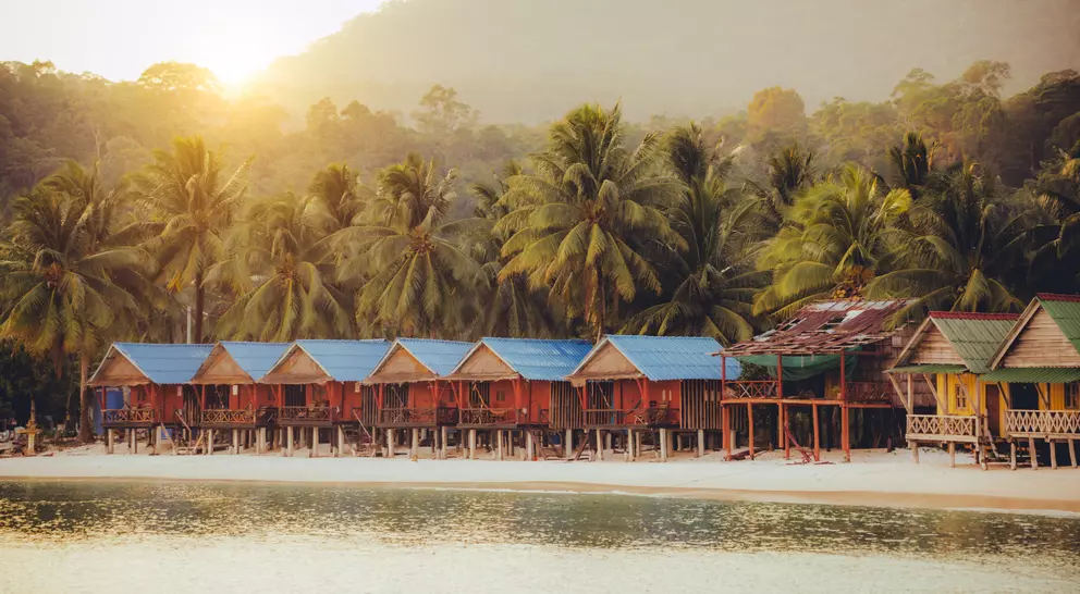 Elevated bungalows along beach with lush palm trees on the secluded Island Koh Rong Sanloem, Sihanoukville Province, Cambodia