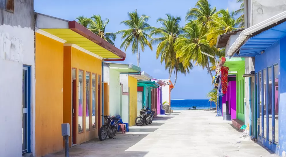Shopping street with typically colorful house facades in Maafushi a local island in the Maldives.
