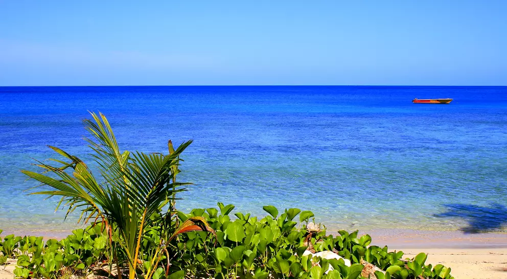Turquoise pacific ocean waters and boat