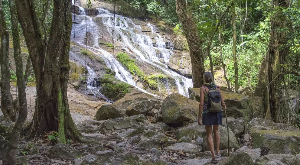 Woman approaching Bocawina Falls. Bocawina National Park, Belize.