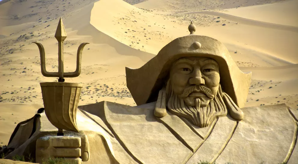 Genghis Khan statue in the middle of Badain Jaran desert. This desert is home to some of the tallest stationary dunes on Earth