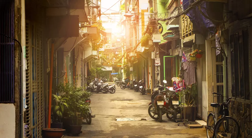 Motor bikes lined down narrow street of Ho Chi Minh city, Vietnam