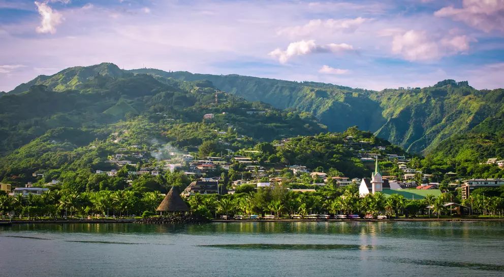 Landscape of Tahiti with mountains and village close to the port of Papeete, French Polynesia