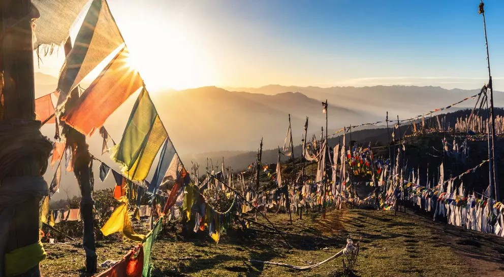 Sunrise at 4000 meters at the highest pass of Bhutan, Chele la with prayer flags flying in the wind