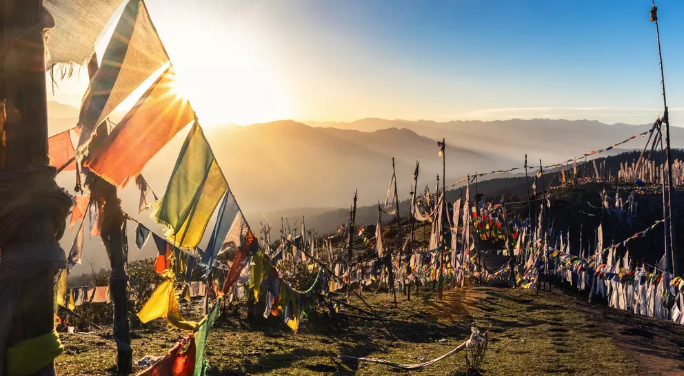 Sunrise at 4000 meters at the highest pass of Bhutan, Chele la with prayer flags flying in the wind