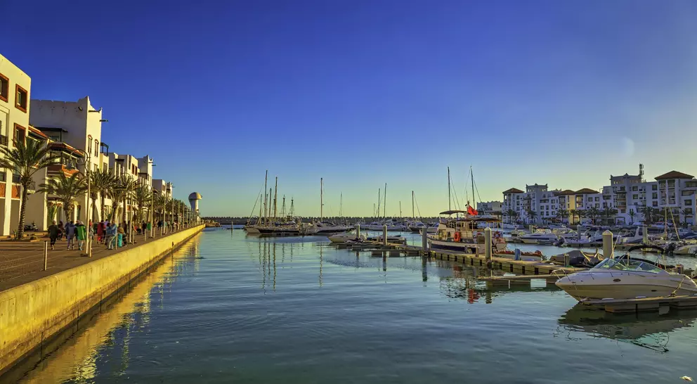 marina with boats and old buildings along the sea