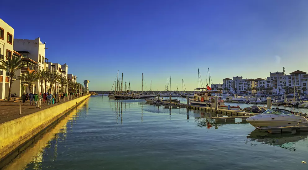 marina with boats and old buildings along the sea