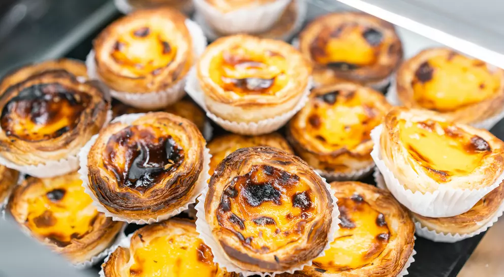 Rows of egg tarts at a bakery in Lisbon, Portugal