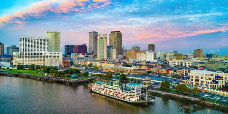 Skyline of city along the Mississippi river, steamboat in foreground