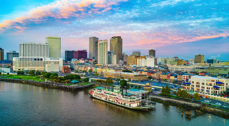 Skyline of city along the Mississippi river, steamboat in foreground