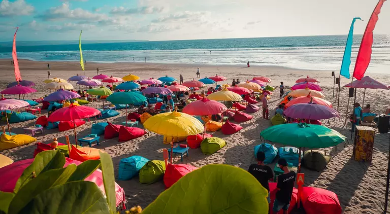 Colourful beach umbrellas with view of Double Six Beach, Seminyak, Bali, Indonesia