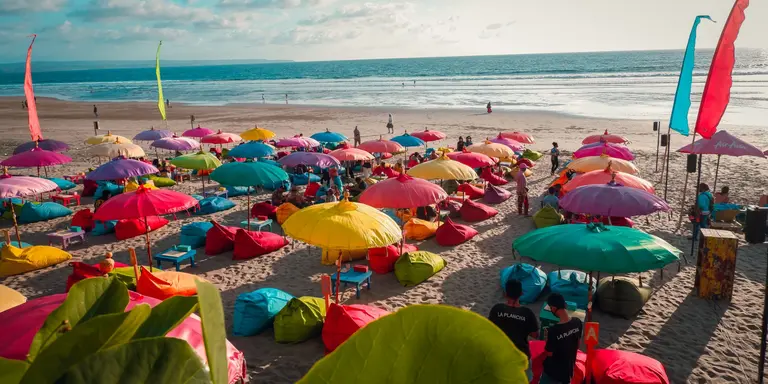 Colourful beach umbrellas with view of Double Six Beach, Seminyak, Bali, Indonesia