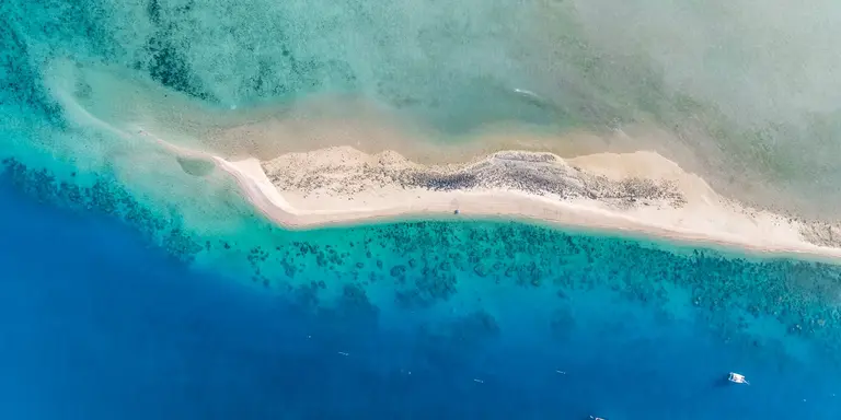 High angle aerial drone view of the sandbar and blue waters