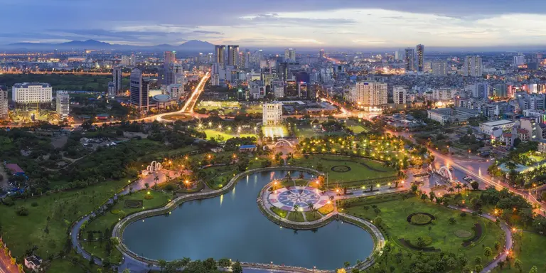 Hanoi skyline cityscape at twilight period, with Cau Giay Park in foreground
