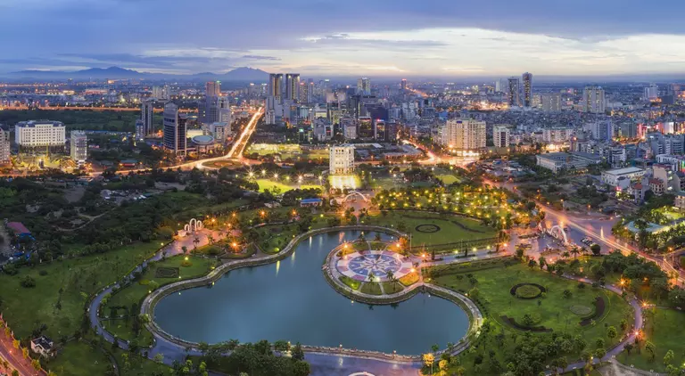 Hanoi skyline cityscape at twilight period, with Cau Giay Park in foreground