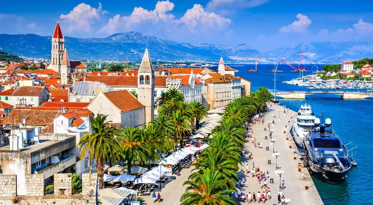 Sunny promenade along the pier of old Venetian town, Dalmatian Coast.
