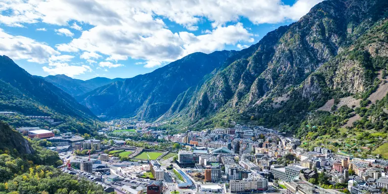 Expansive aerial view revealing the dense urban landscape nestled among the mountains of Andorra