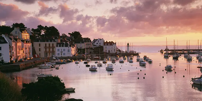 Harbour with boats in the water at sunset