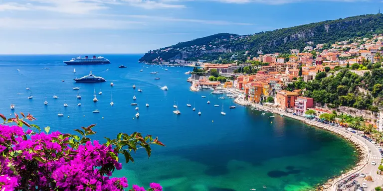 Aerial view of the vibrant town and beach with boats in the water
