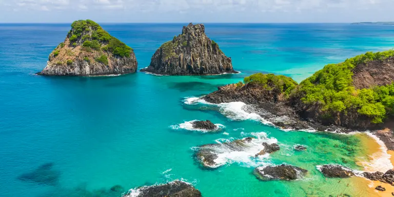 Aerial view of tropical island coastline with beautiful waters