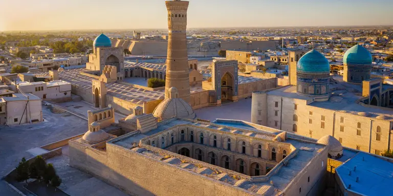 Sunset over the famous Kalyan Poi Kalon Minaret, Poi Kalan or Po-i-Kalyan and Mir Arab Madrasah in the center of the old town of Bukhara