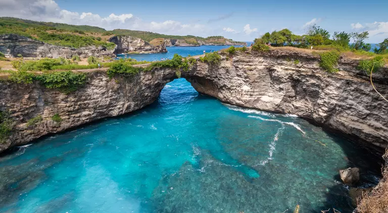 Stone arch over the sea called Broken beach on Nusa Penida ,Indonesia