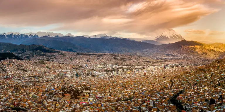 Panoramic view of La Paz, Bolivia, during sunset with Illimani Mountain rising in the background