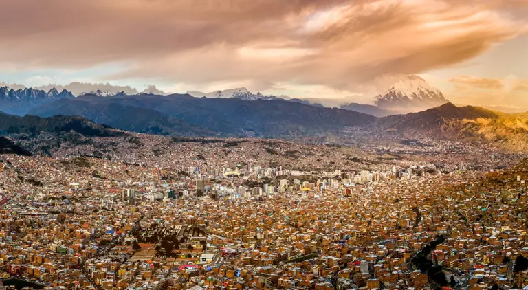 Panoramic view of La Paz, Bolivia, during sunset with Illimani Mountain rising in the background