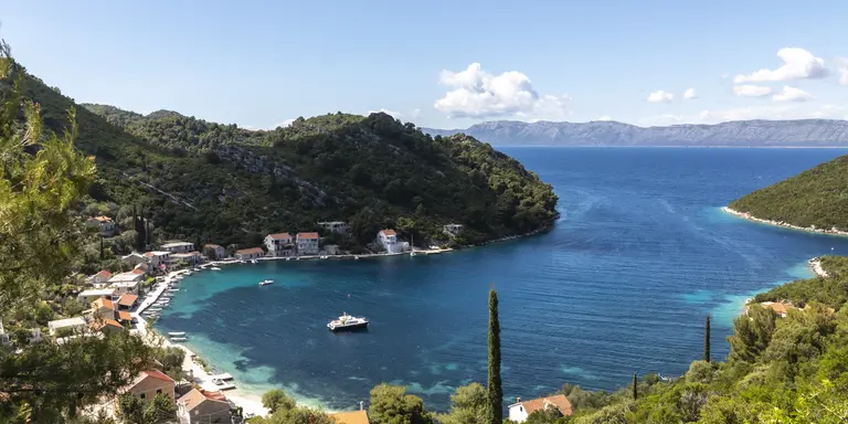 Rural village nestled on bay surrounded by blue waters