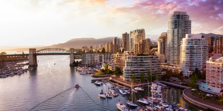 iew of Burrard Bridge and False Creek in downtown, taken during a beautiful cloudy sunset.
