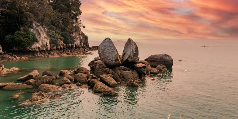 Famous rock and tourist site in national park with sunset in the background