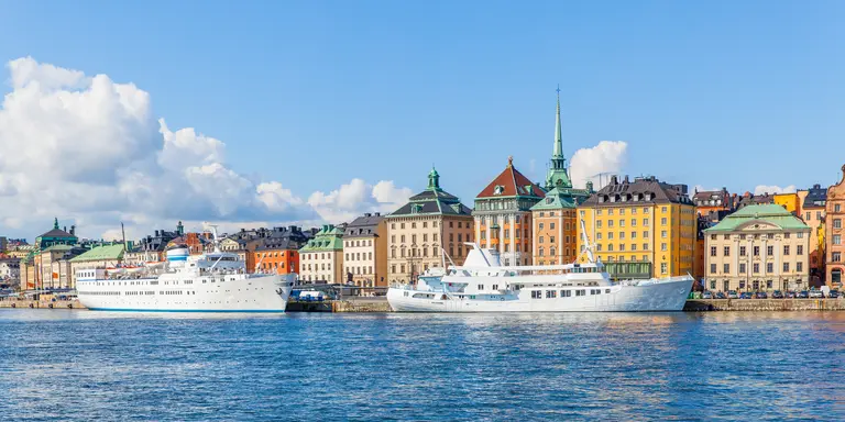 Panoramic view of waterfront with moored ships in the Old Town (Gamla stan)