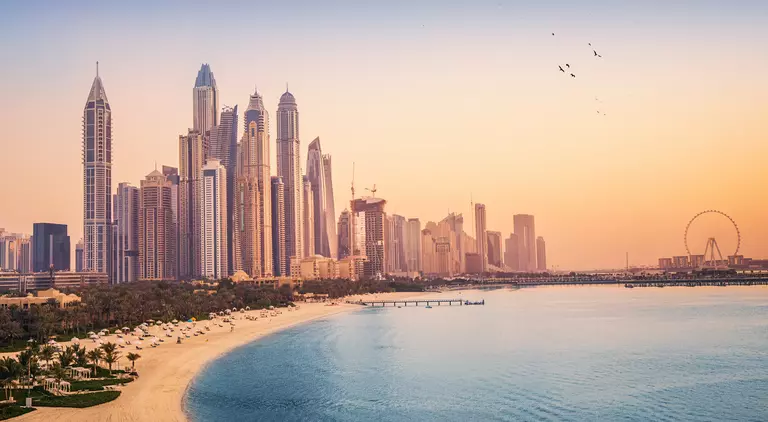 Sunset view of the Dubai Marina and tthe golden sand beaches in the Persian Gulf