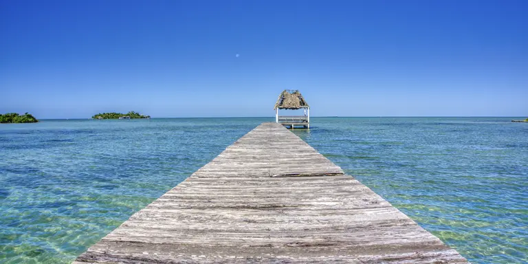 Pier over the blue sea on San Pedro Island in the Caribbean nation of Belize