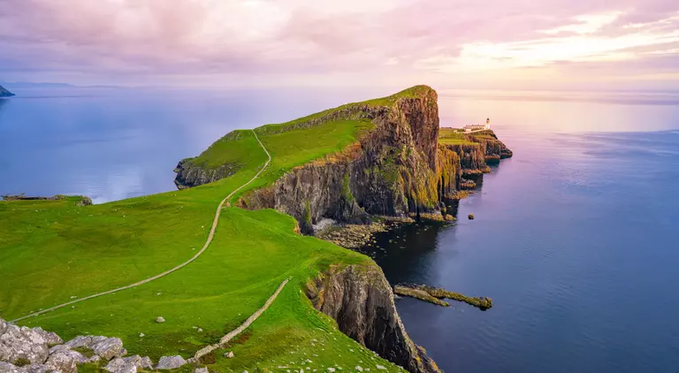 Lightouse at edge of cliff overlooking atlantic ocean