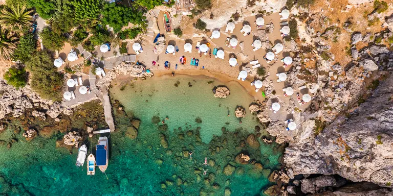 Aerial photo of beach goes and boats in the bay