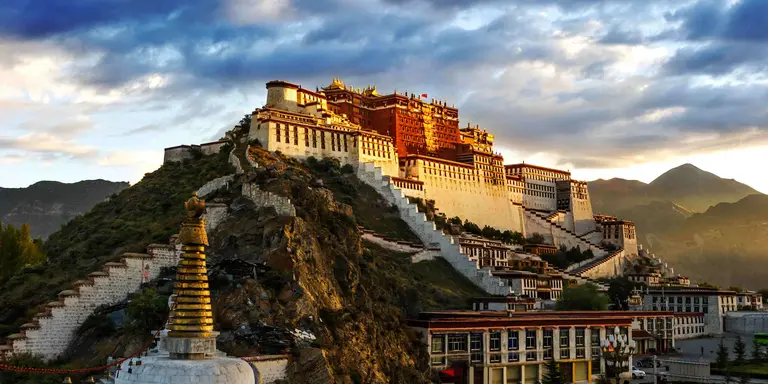 The red and white Potala Palace, is built on Red Mountain in the centre of Lhasa Valley and is the winter palace of the Dalai Lama